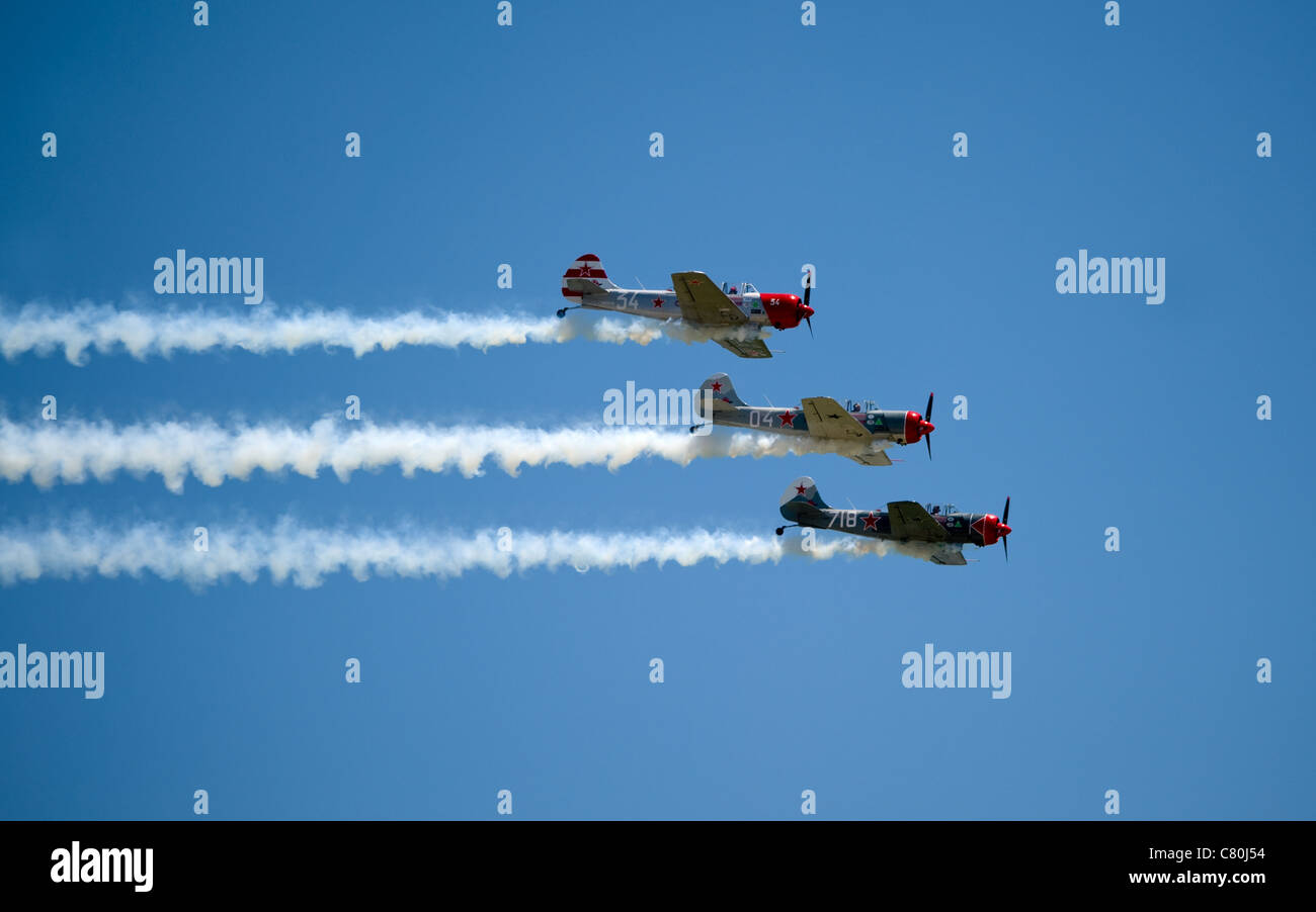 three show planes perform in the air show fest maneuver up side down Stock Photo