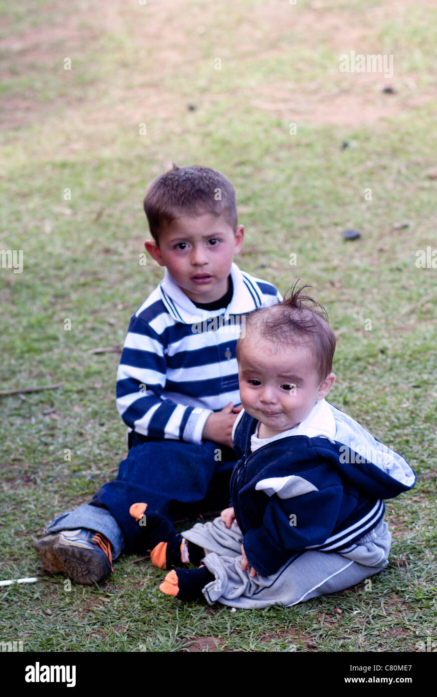 Children sitting on grass. Toca, Boyacá, Colombia, South America Stock Photo