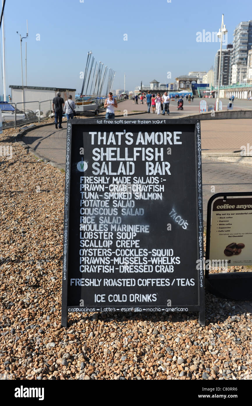 A Board sign on Brighton seafront advertising Thats Amore shellfish and