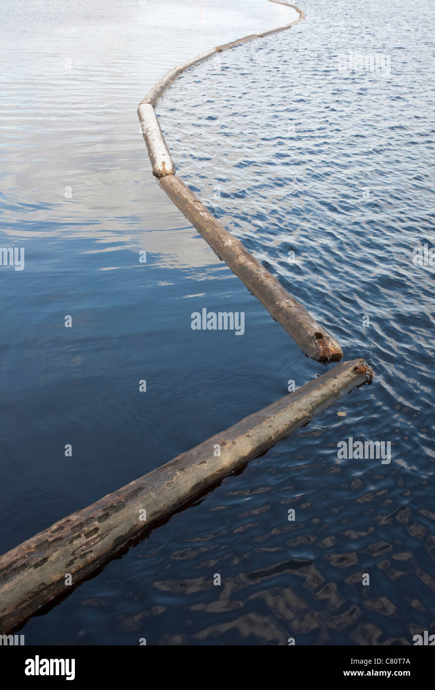 log boom barrier floating on water Stock Photo