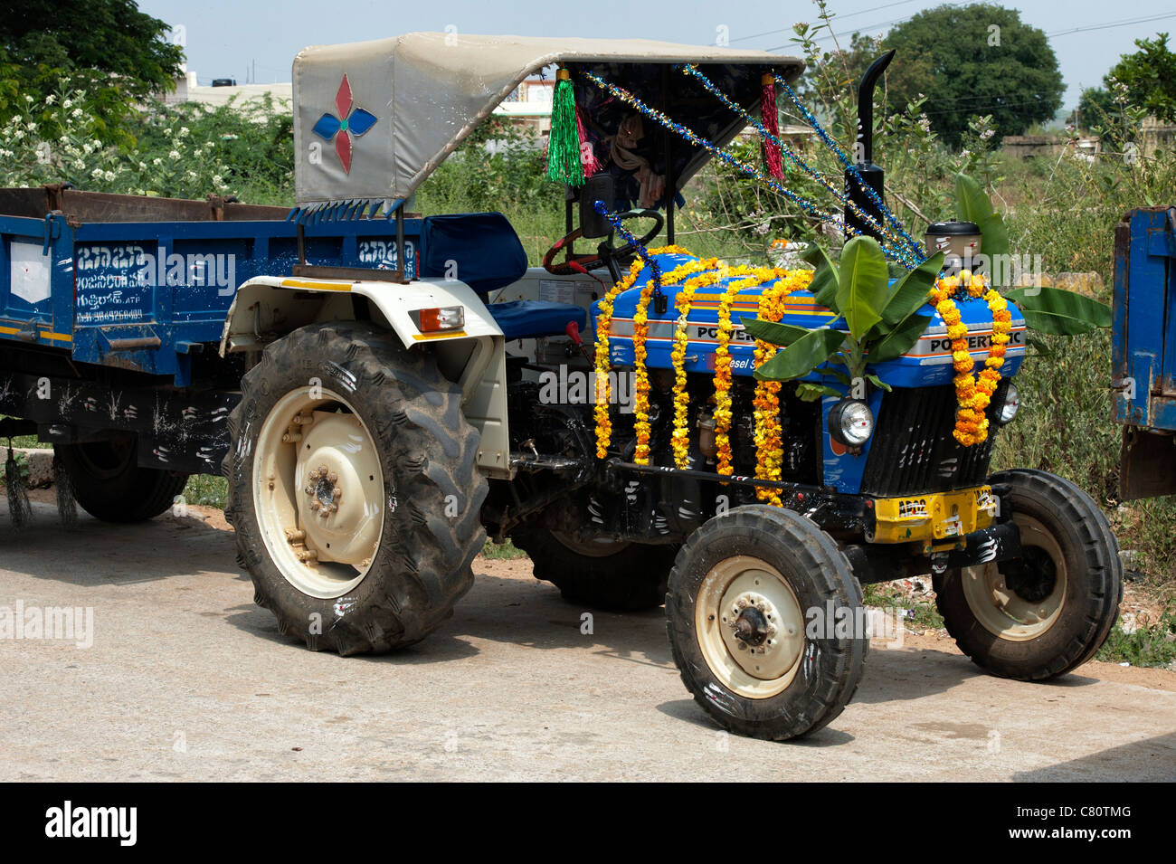 Indian tractor covered in flower garlands during the Hindu festival of Dasara. Andhra Pradesh, India Stock Photo