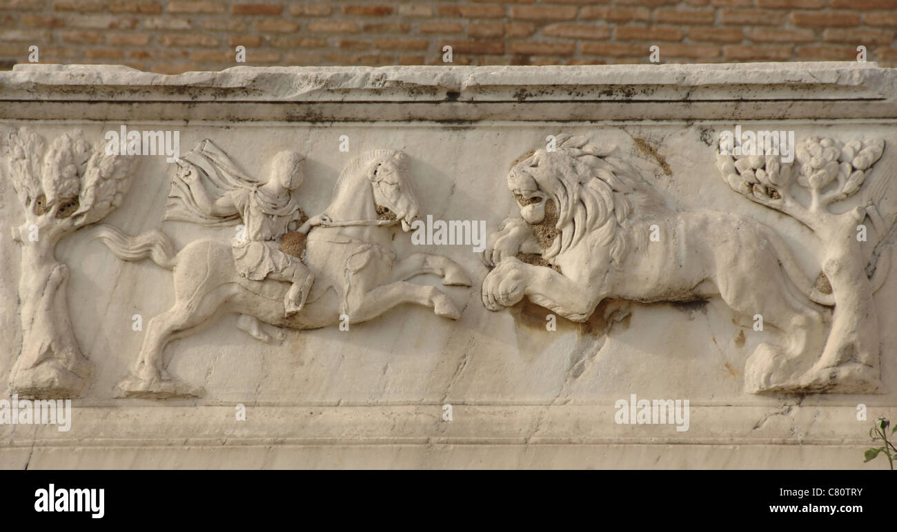 Roman Art. Greece. Relief in a Roman tomb around the Odeon. It depicts a Roman soldier on horseback fighting a lion. Patras. Stock Photo
