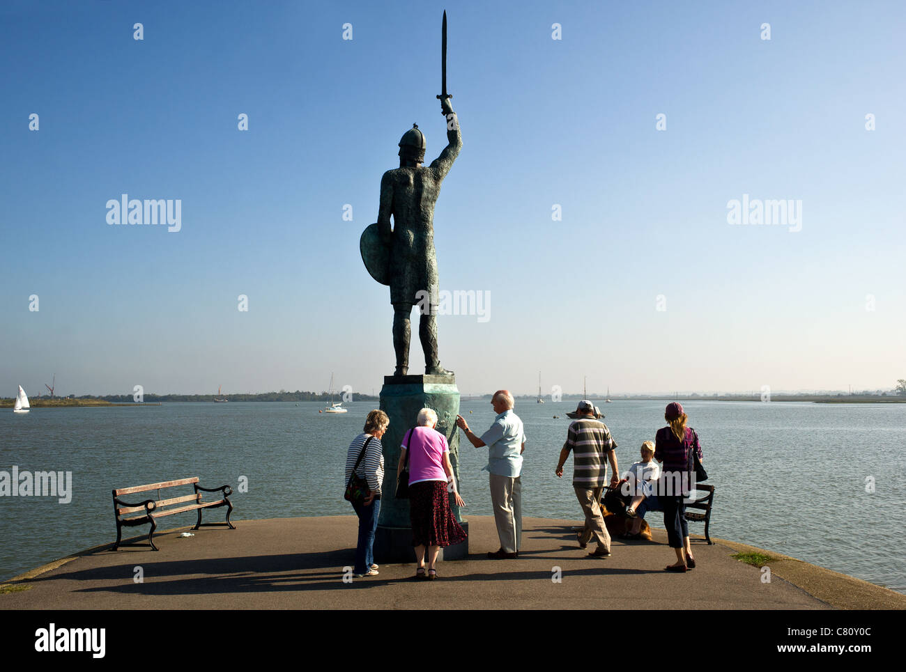 Tourists visitors looking at the bronze statue of Byrhtnoth on the Promenade Walk in Maldon Essex. Stock Photo