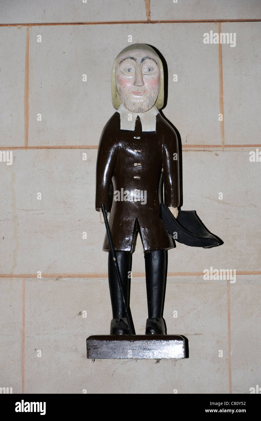 Replica figure of a mendicant, hat in hand, standing above the poor box in the Cathedral and Abbey Church of St Alban Stock Photo