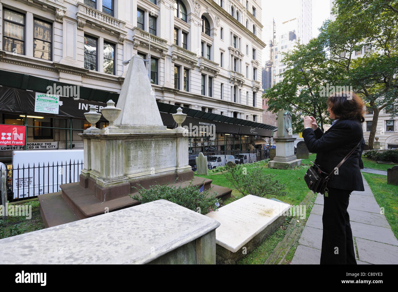 A tourist photographing the grave of Alexander Hamilton, which is in Trinity churchyard in Lower Manhattan's financial district. Stock Photo