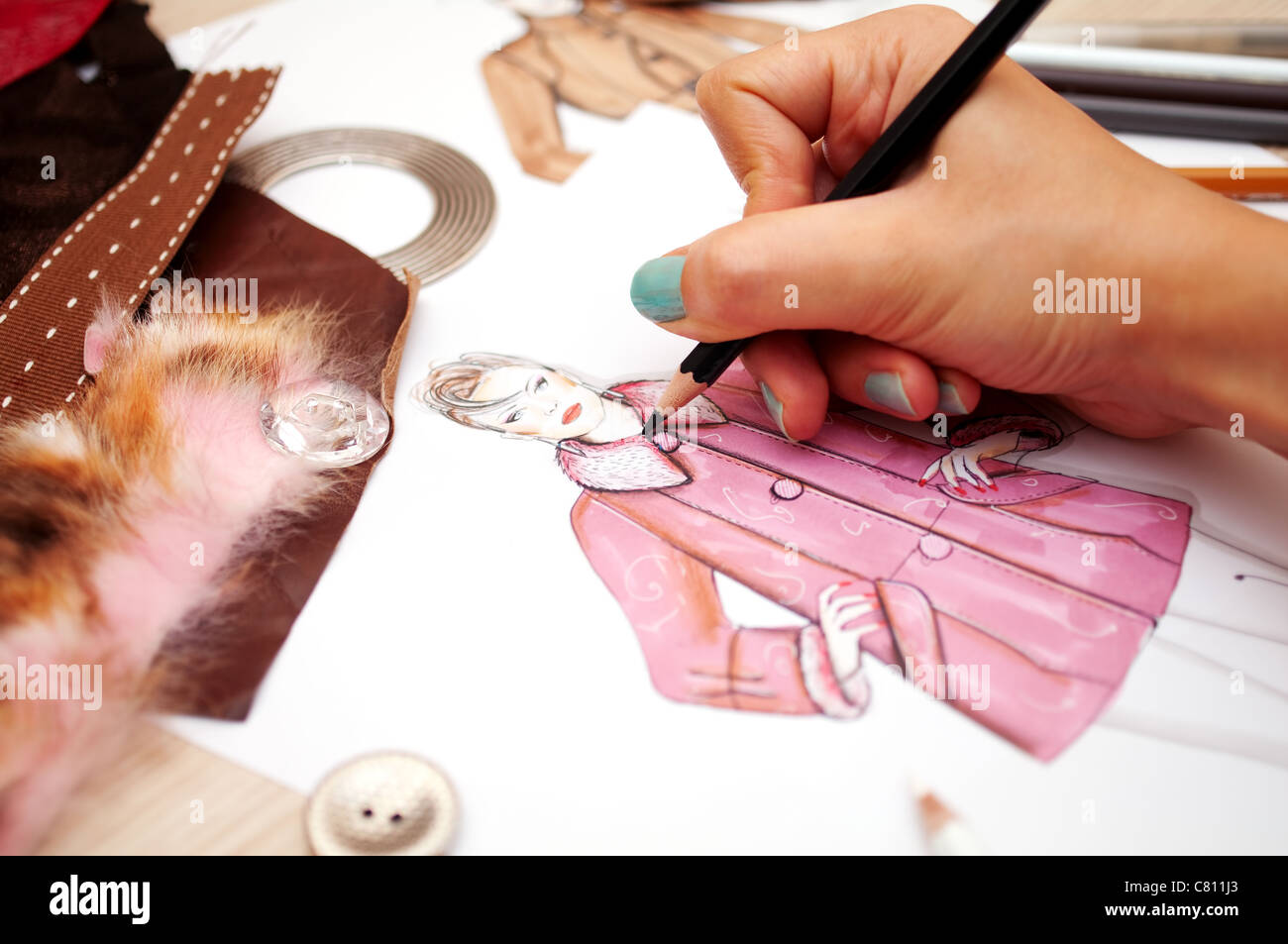 Fashion designer is drawing a fashion sketch for autumn-winter season Stock Photo