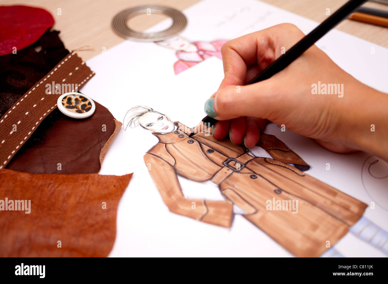 Fashion designer is drawing a fashion sketch for autumn-winter season Stock Photo