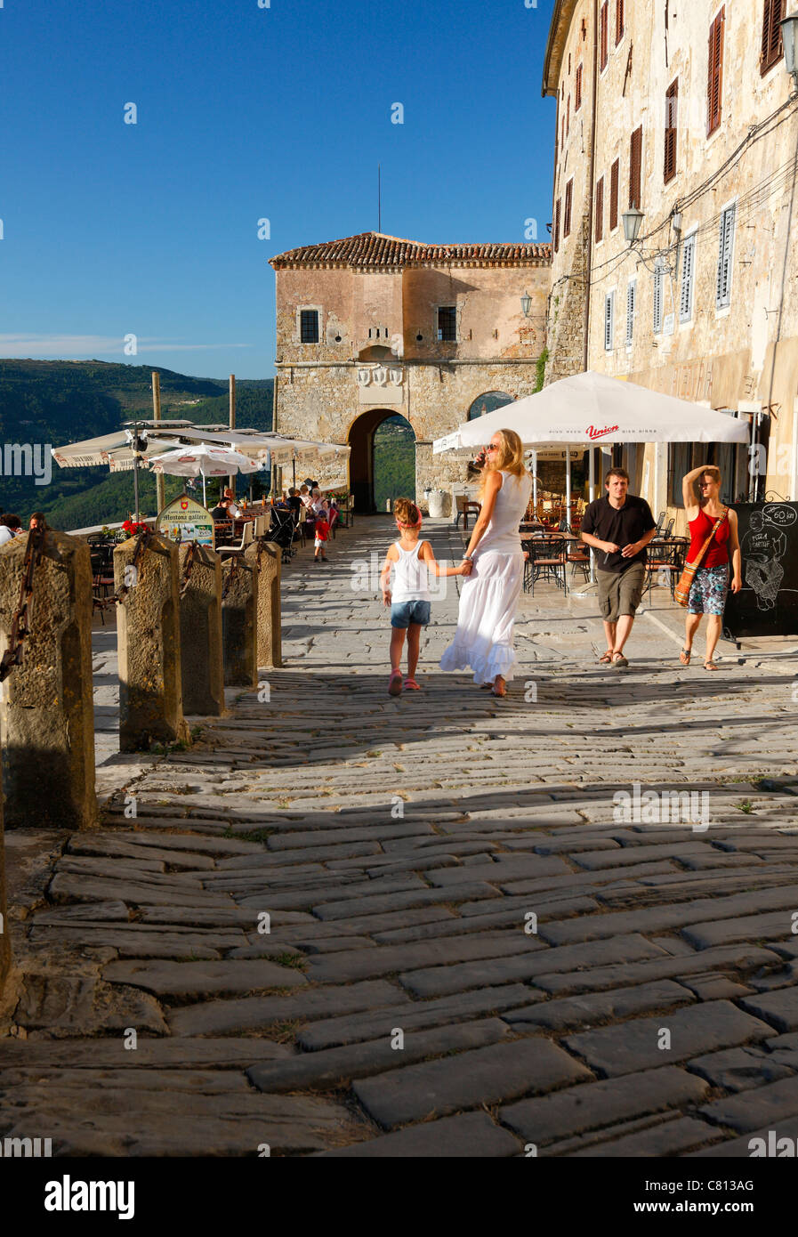 People walking on old street of Motovun in Istria. Stock Photo