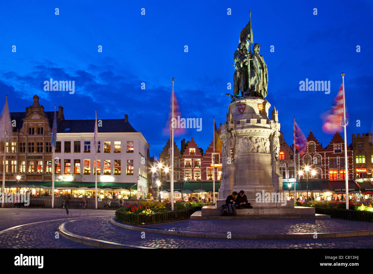 Historical statue in Grote Markt, Market Square, at dusk twilight in Bruges, Brugge, Flanders, Belgium Stock Photo