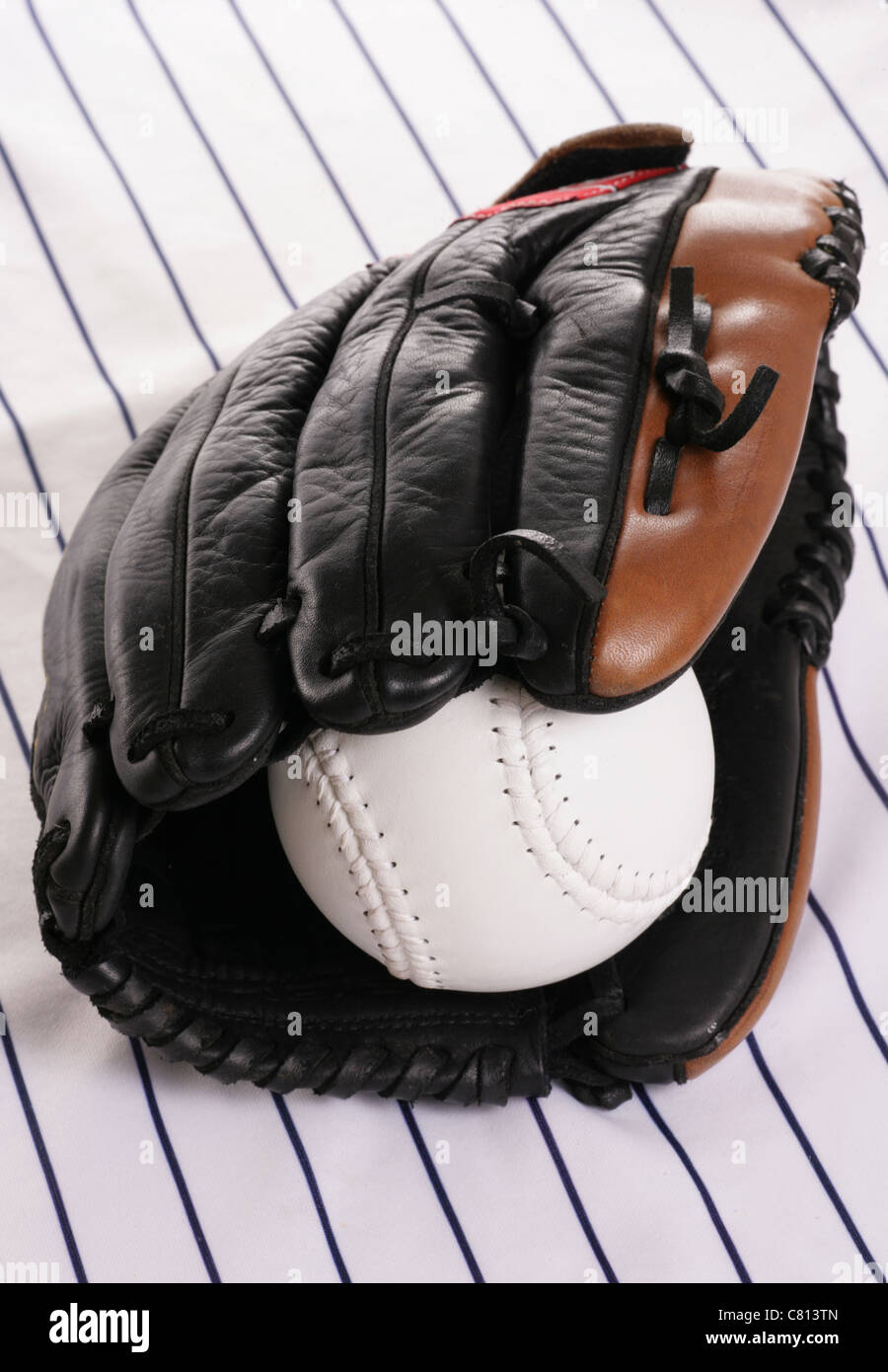 glove and softball on pin stripe Stock Photo