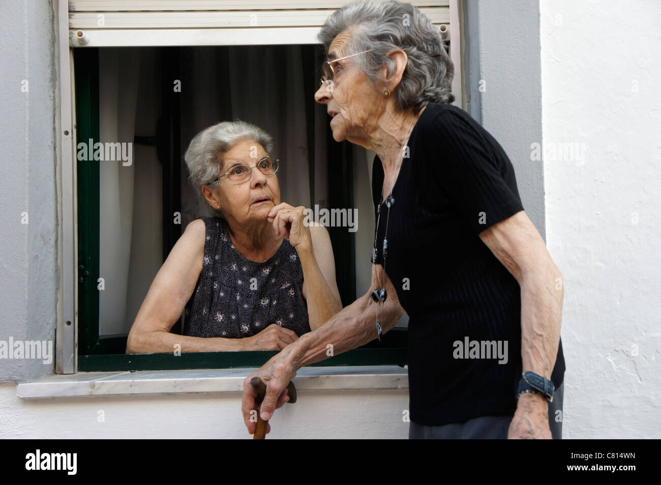 Two elderly women talking gossip Stock Photo