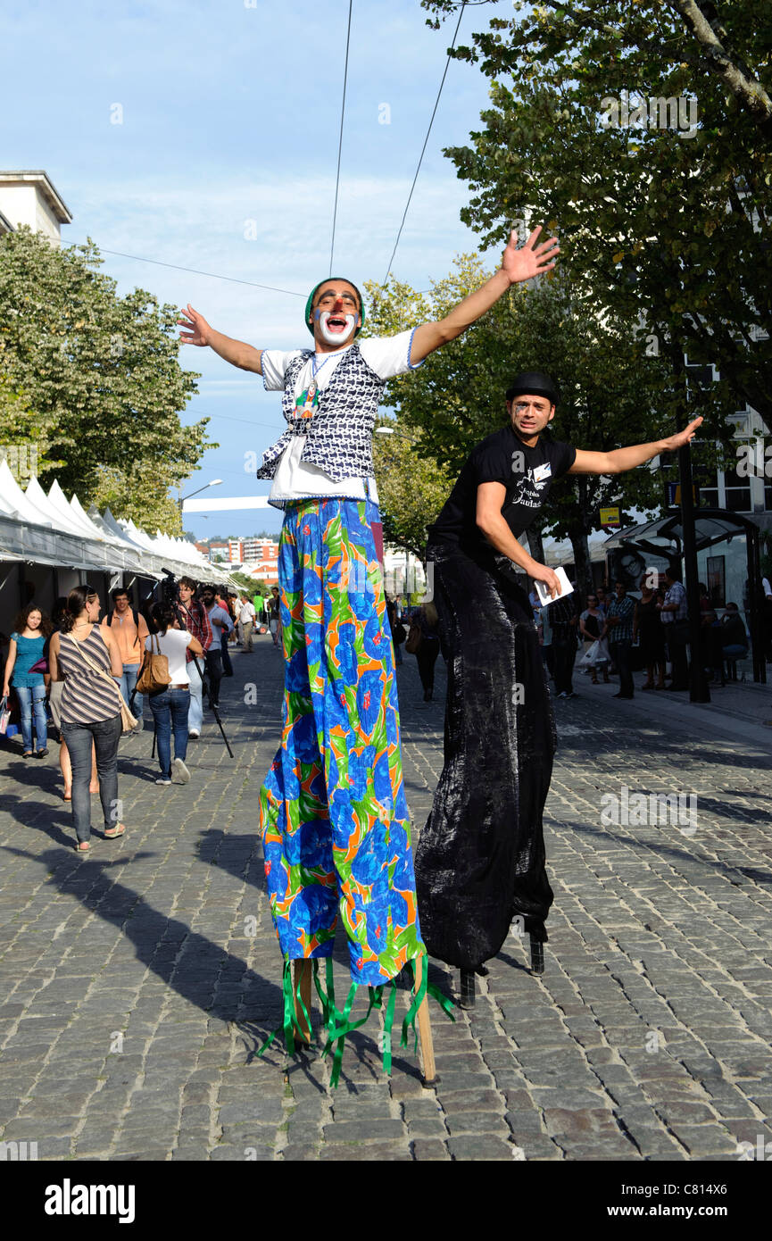 Stilt walkers clowns street entertainers Stock Photo