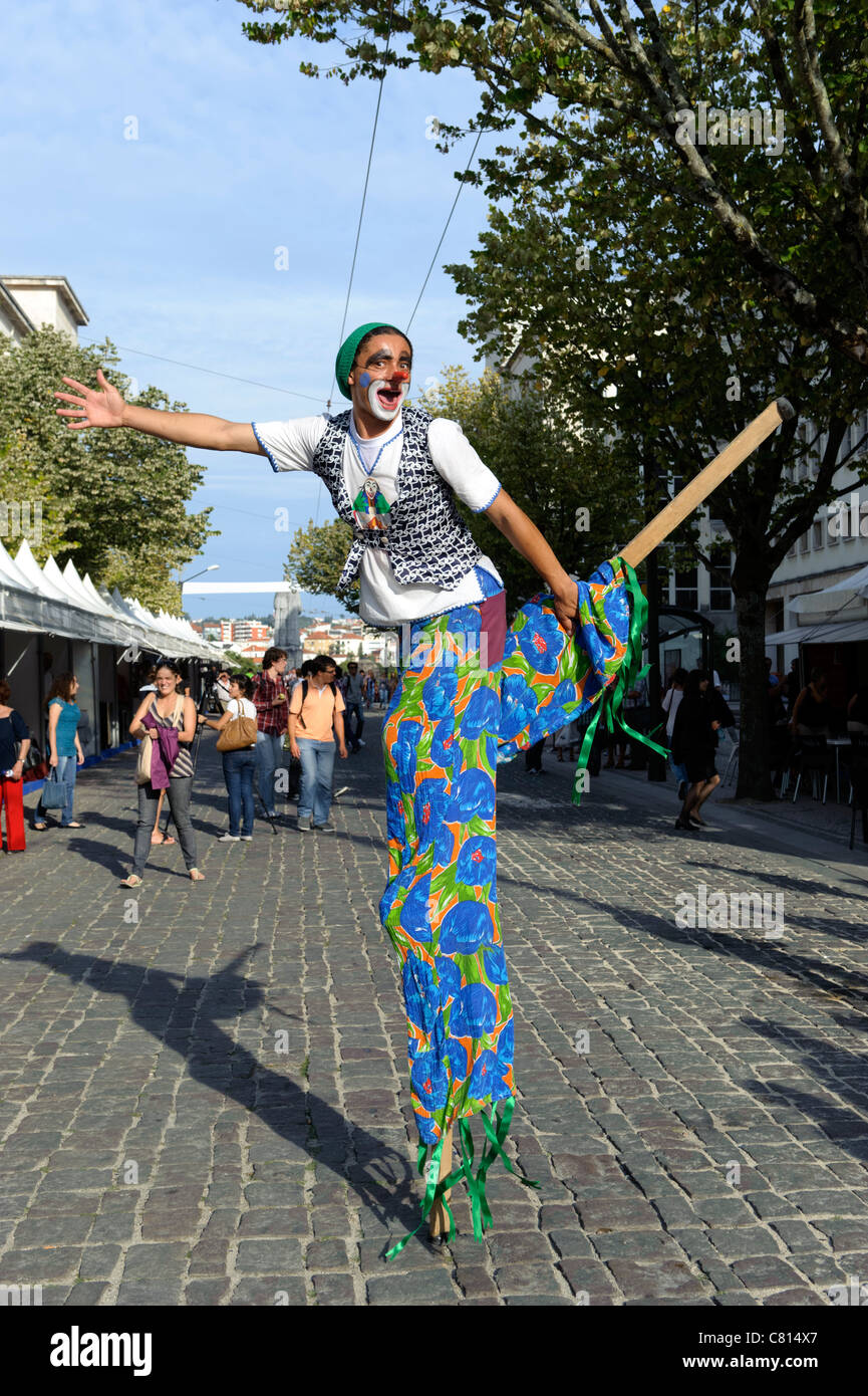 Stilt walker clown street entertainer Stock Photo