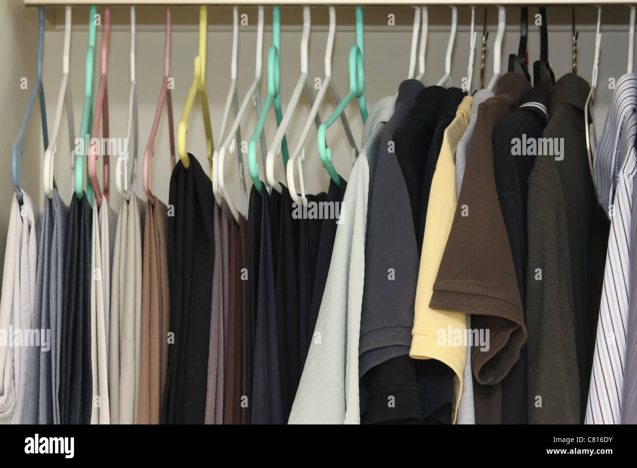 men closet hangers pants polos Stock Photo