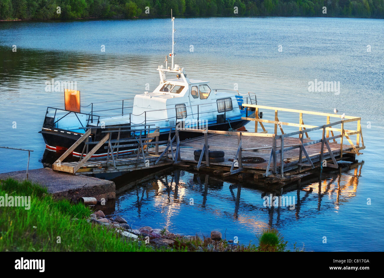 patrol boat docked on calm lake at evening Stock Photo