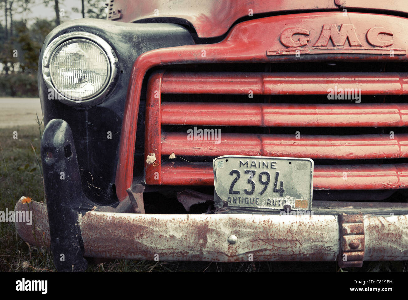 The front of an old broken down GMC truck Stock Photo