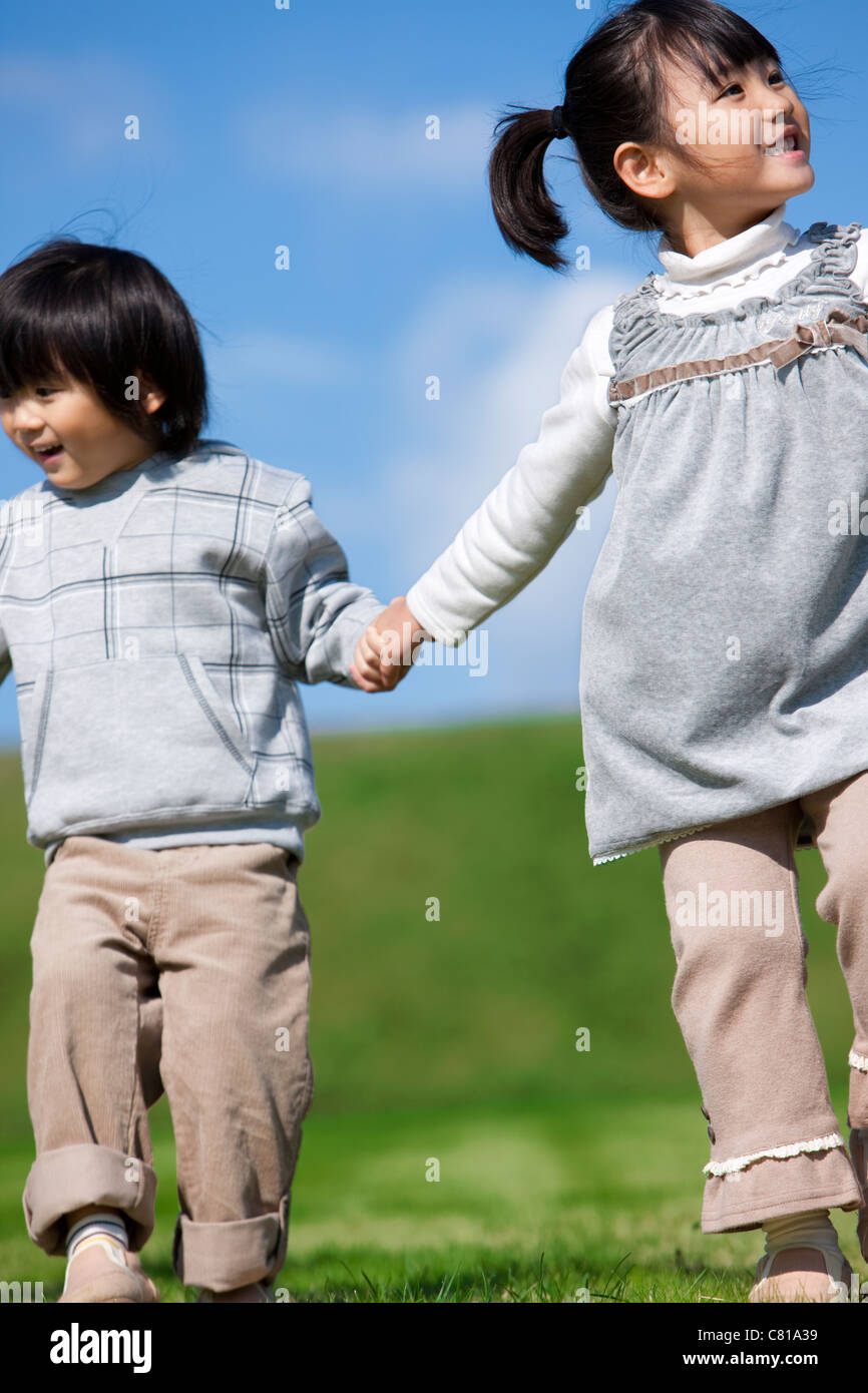 Sister and Brother Holding Hands Stock Photo - Alamy
