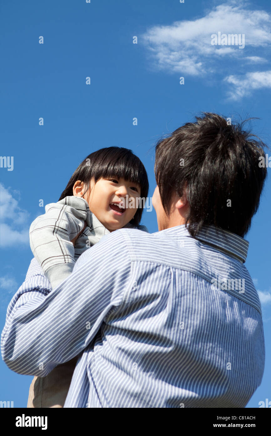 Father and Boy Against Blue Sky Stock Photo - Alamy