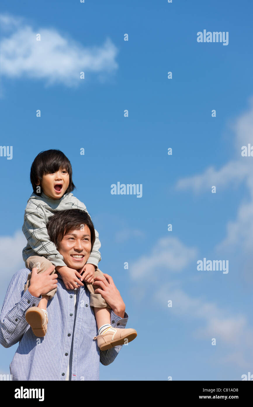 Father Carrying Boy on Shoulders Stock Photo - Alamy