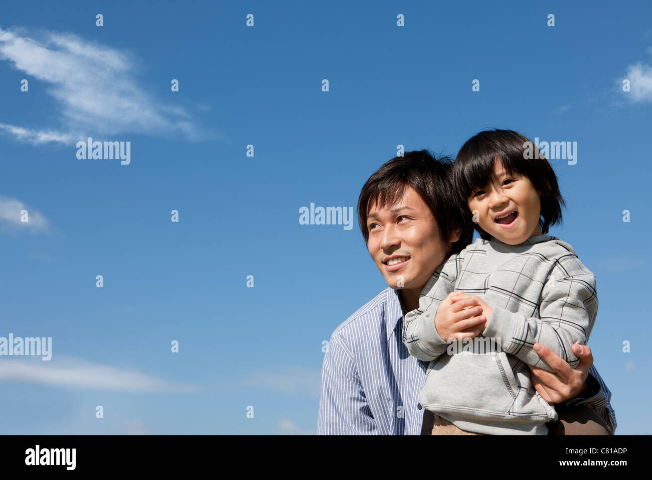 Father and Boy Against Blue Sky Stock Photo - Alamy