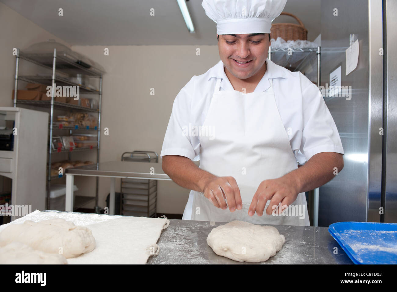https://c8.alamy.com/comp/C81D03/hispanic-baker-working-in-commercial-kitchen-C81D03.jpg