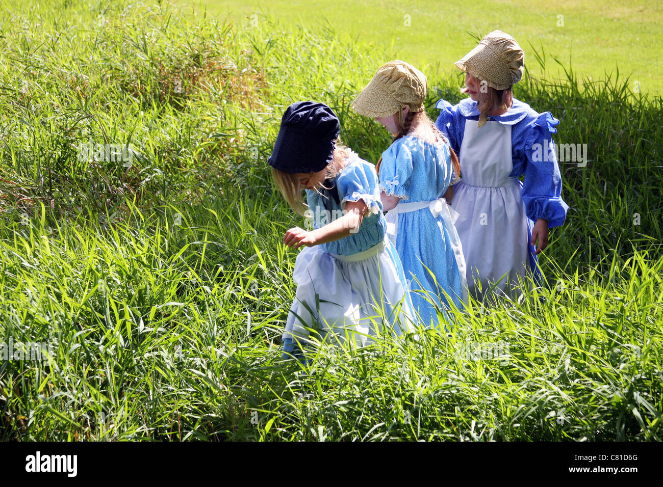 Three young girls holding hands Stock Photo - Alamy