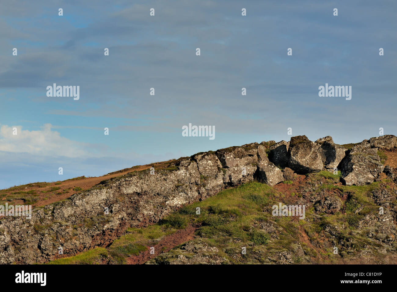 Volcanic rocks including volcanic breccia along the top rim of Kerid, a volcanic crater lake in the Grimsnes area of Iceland Stock Photo