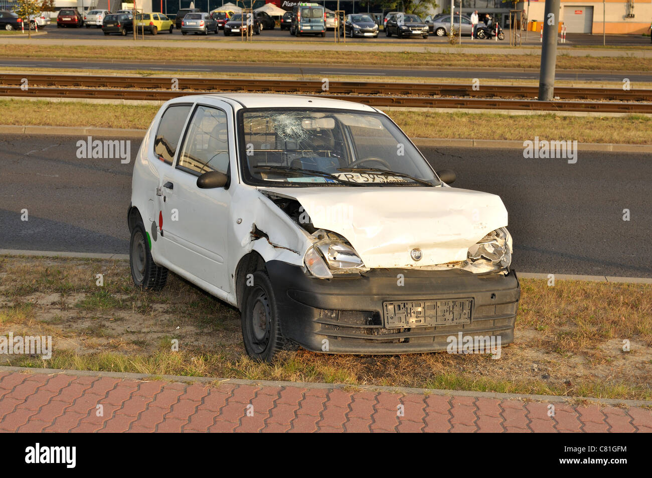 Crashed car near street - Fiat Seicento (600) damaged in an traffic collision Stock Photo
