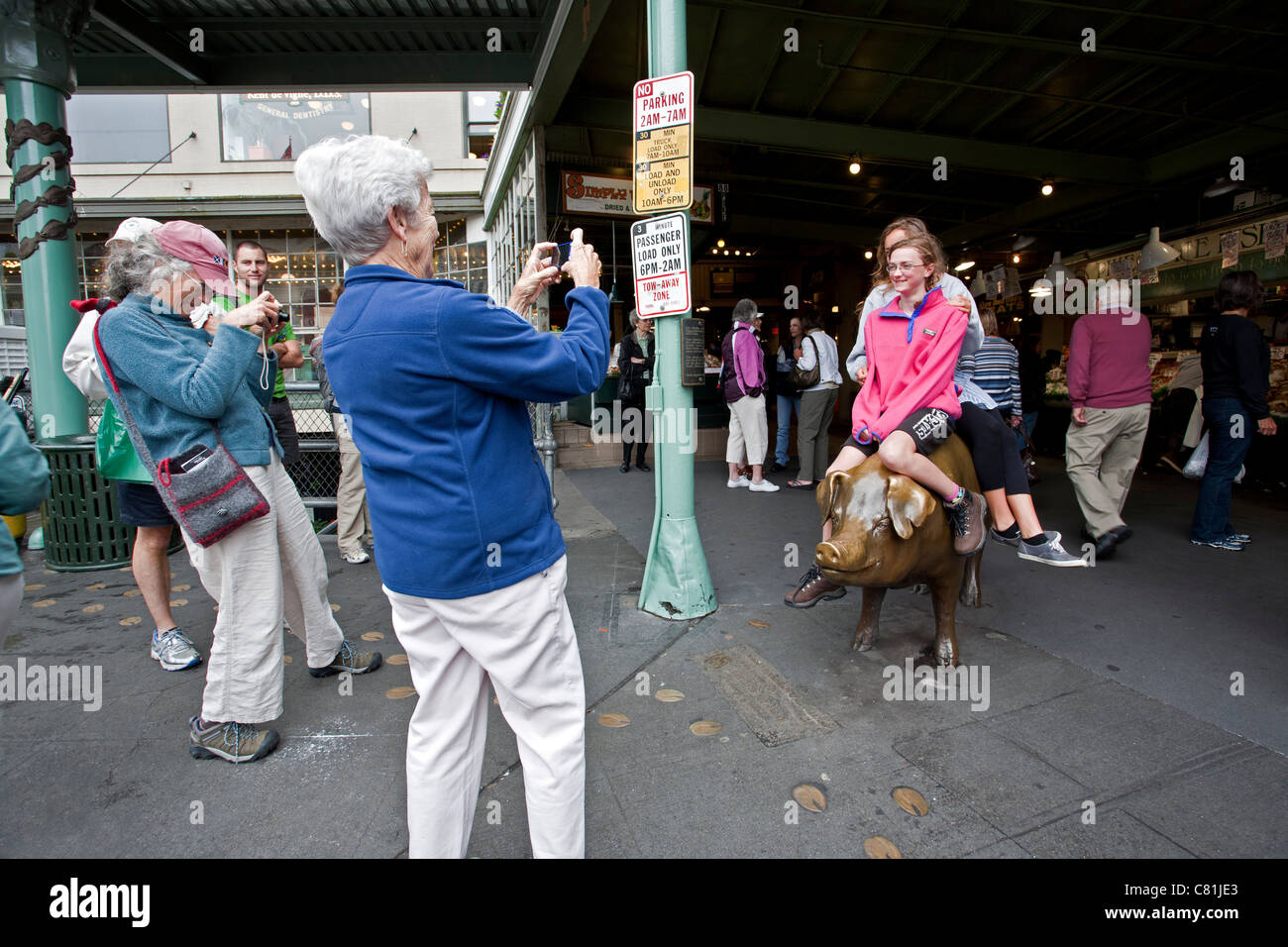 Tourists photographing the pig sculpture (Rachel). Pike Place Market