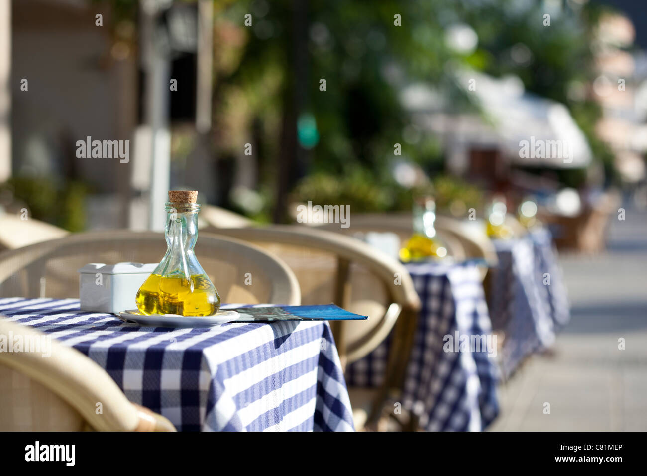 Al Fresco dining olive oil detail on tables outside cafe seafront Port de Pollença Puerto Pollensa Stock Photo