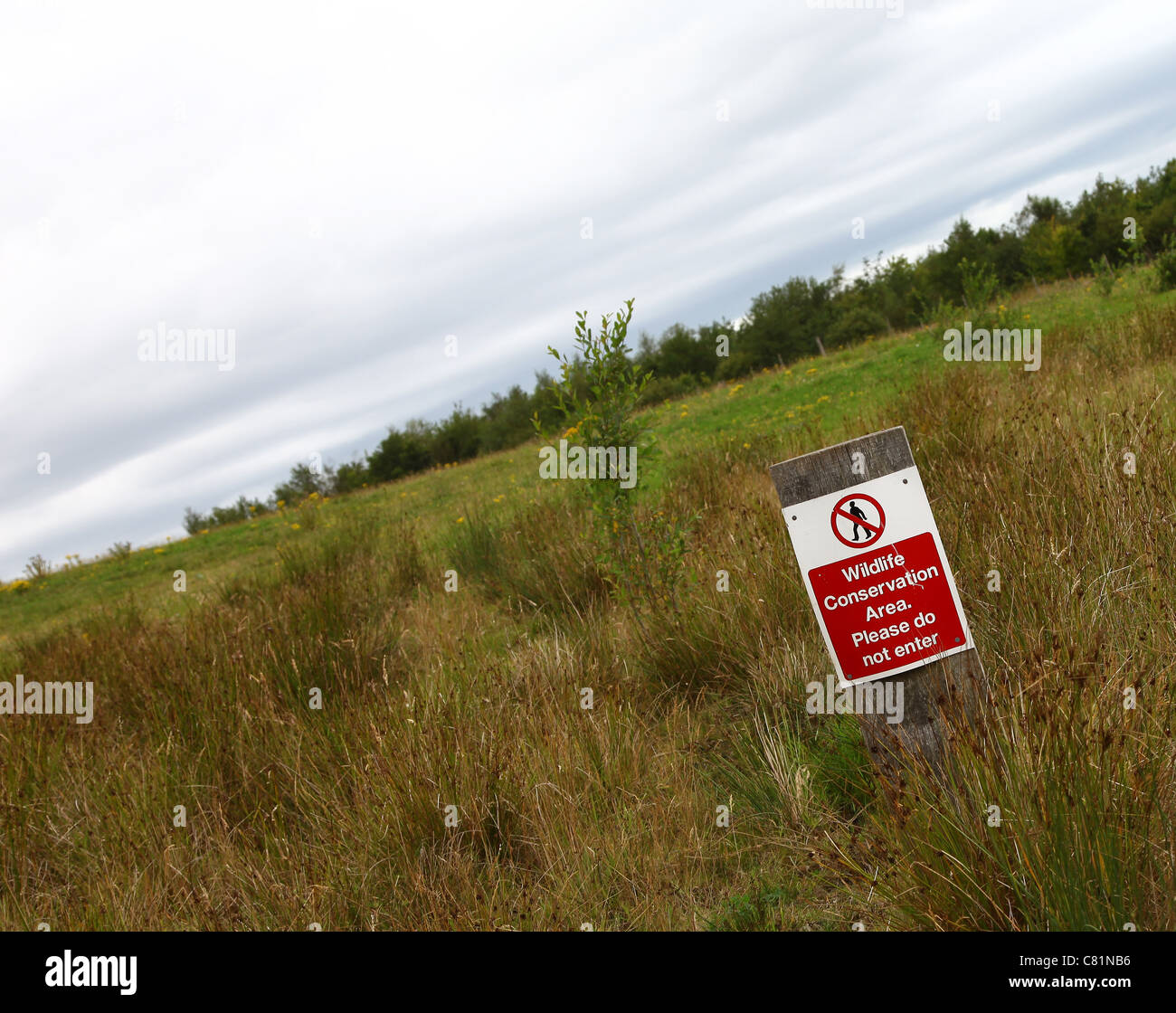 A sign saying wildlife conservation area please do not enter Stock Photo