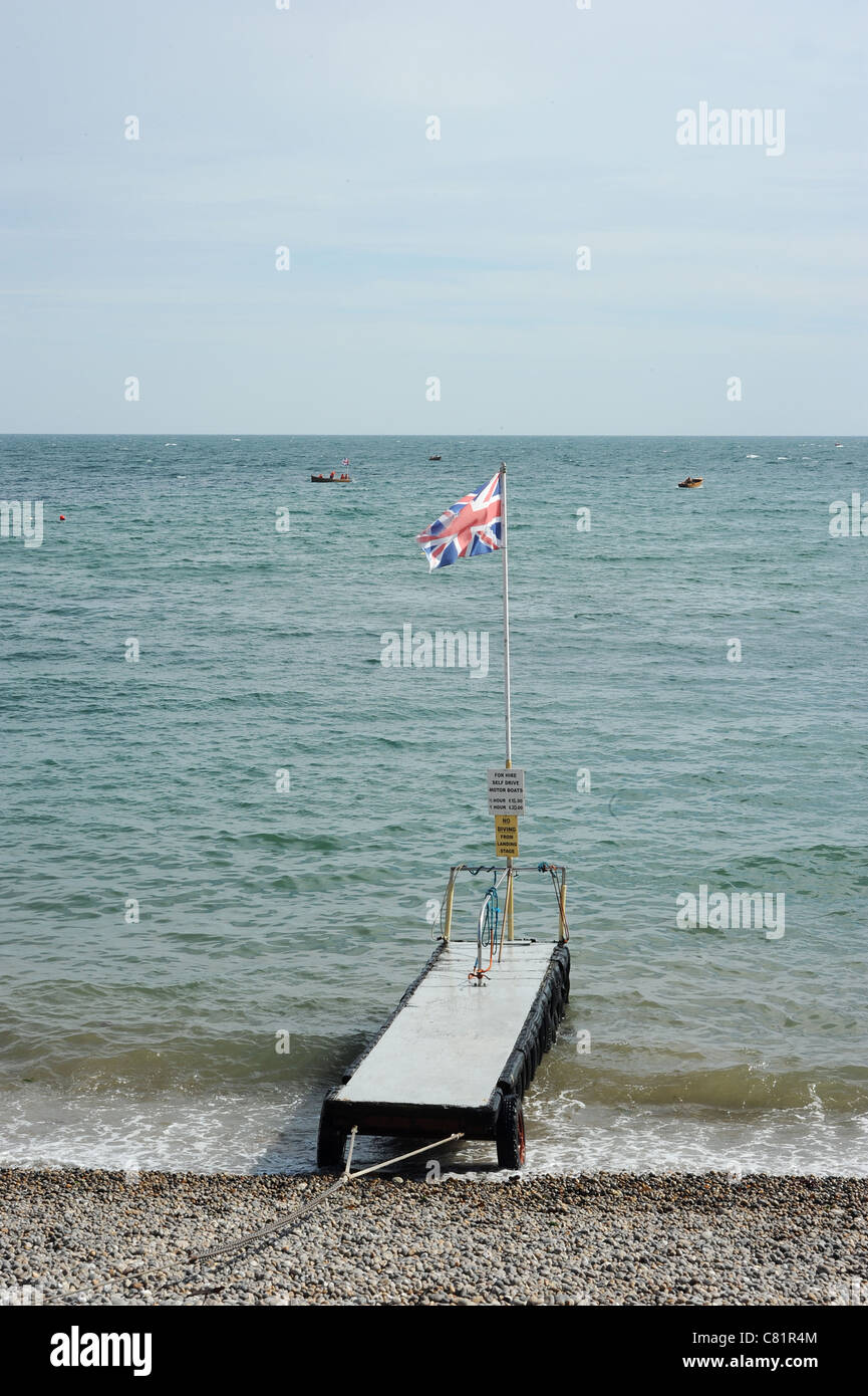 Pier with union jack flag, Beer Beach Devon, England Stock Photo