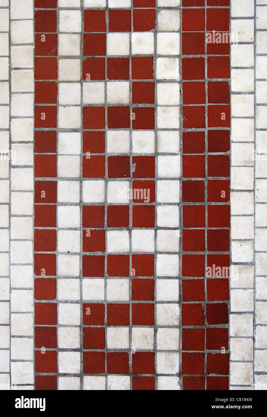 old red serpentine tiled design on white tile background Stock Photo