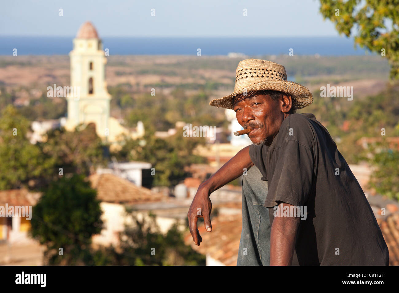 TRINIDAD: LOCAL MAN AT VIEWPOINT OVERLOOKING TRINIDAD OLD TOWN AND CONVENT OF SAN FRANCISCO Stock Photo