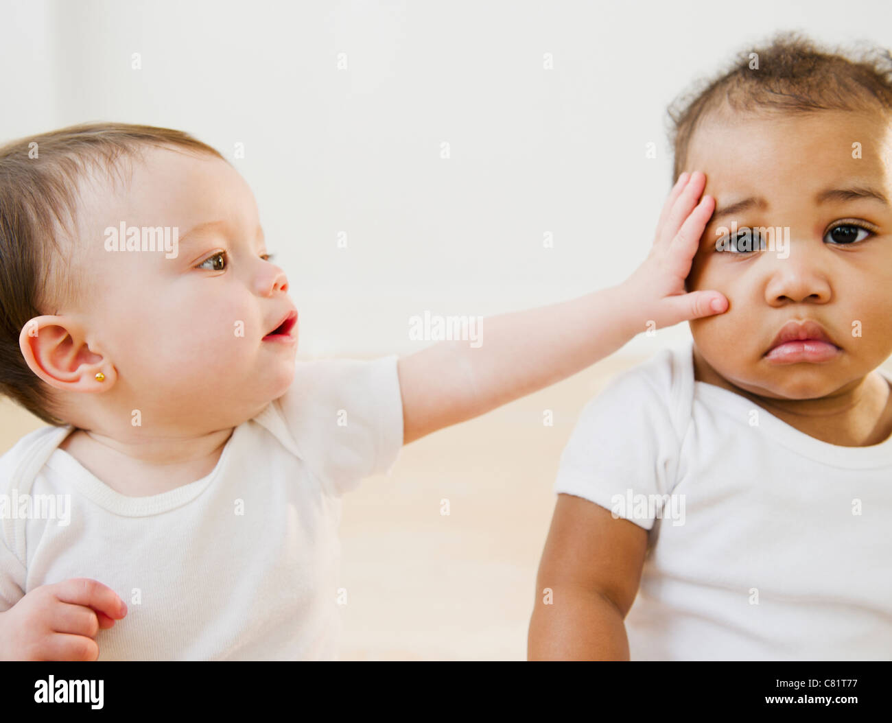 Babies playing together Stock Photo - Alamy