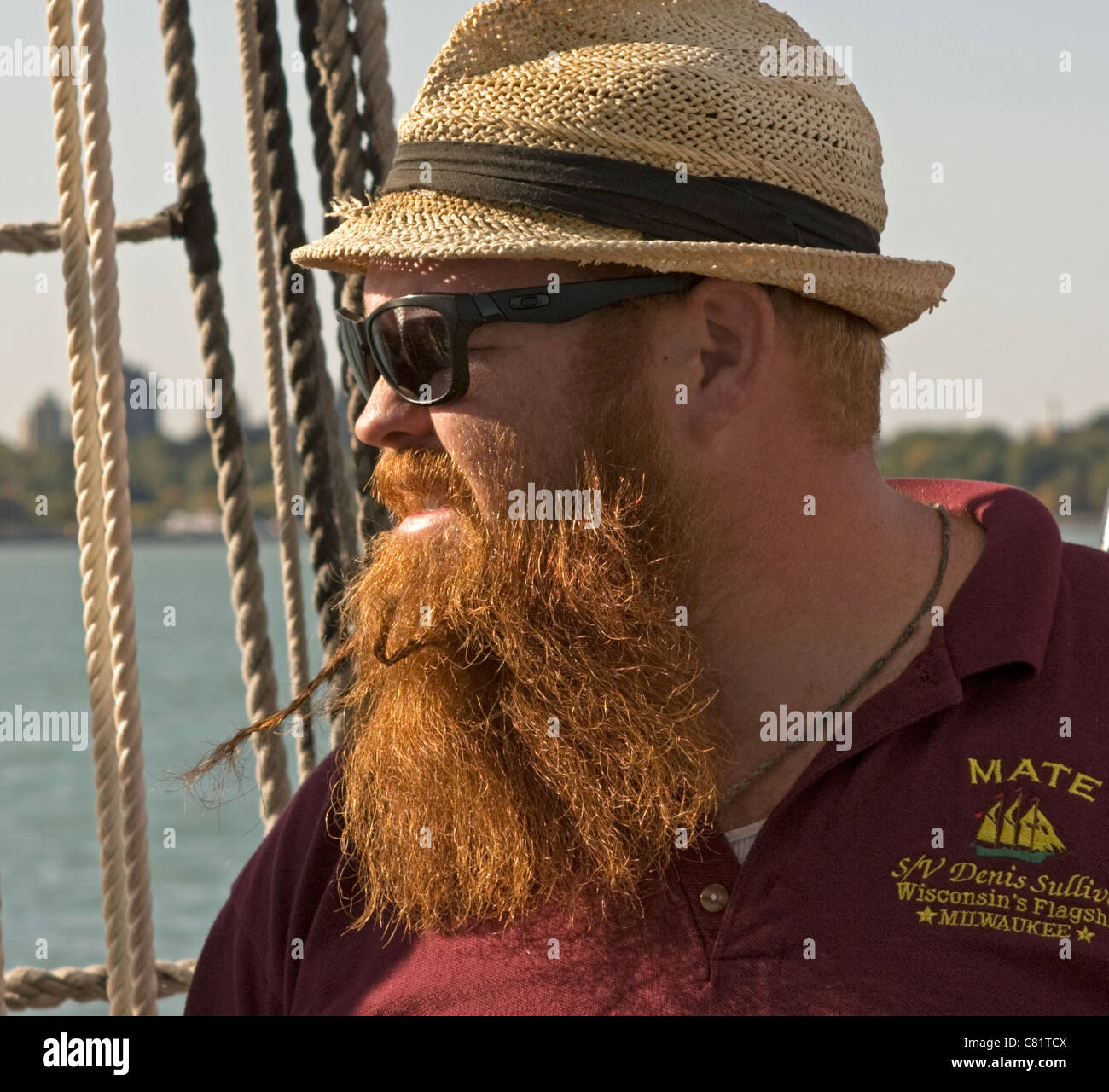 A mate aboard the S/V Denis Sullivan gazes out on the water on a sunny afternoon sail. Stock Photo