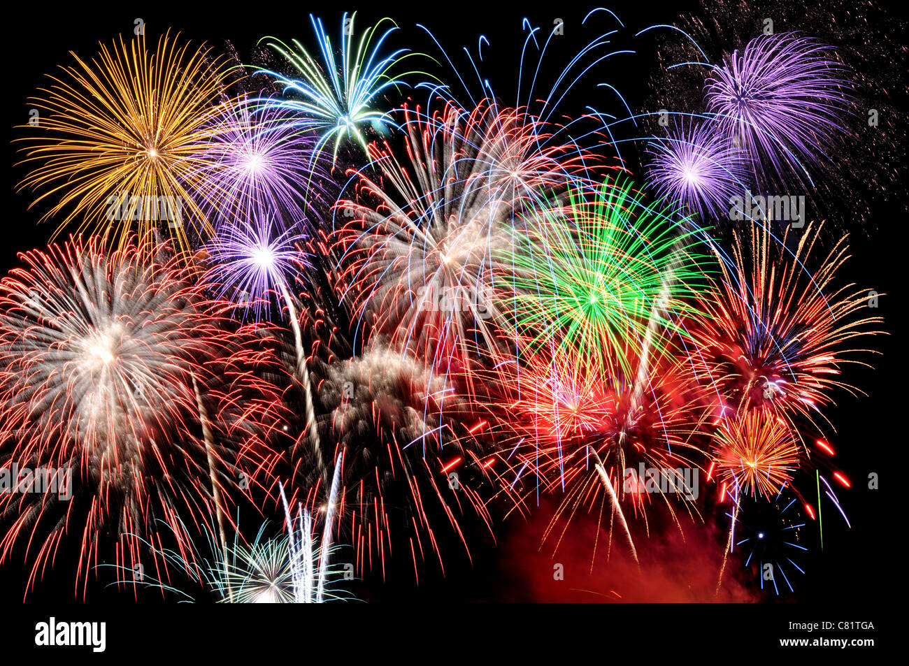 Fireworks of various colors busting against a black sky Stock Photo