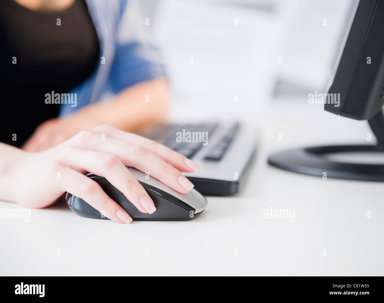 Close up of Korean woman using computer mouse Stock Photo