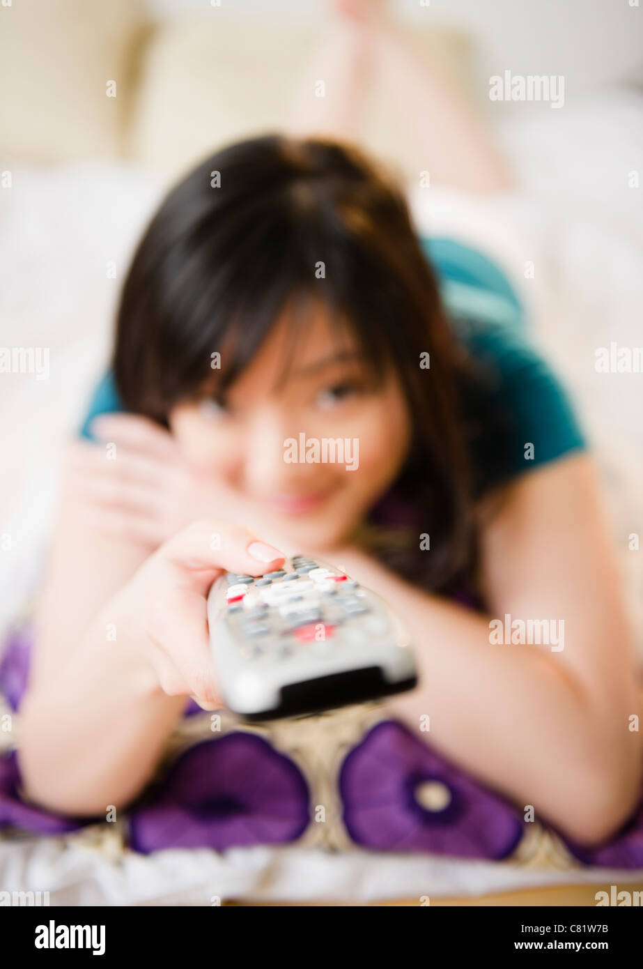 Korean woman holding remote control Stock Photo