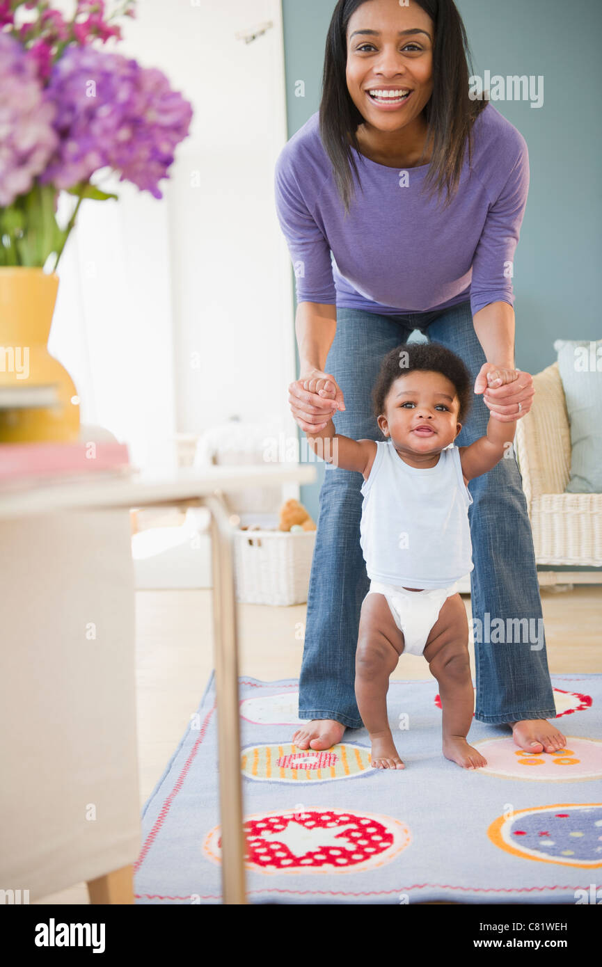 Mother helping young boy walk hires stock photography and images Alamy