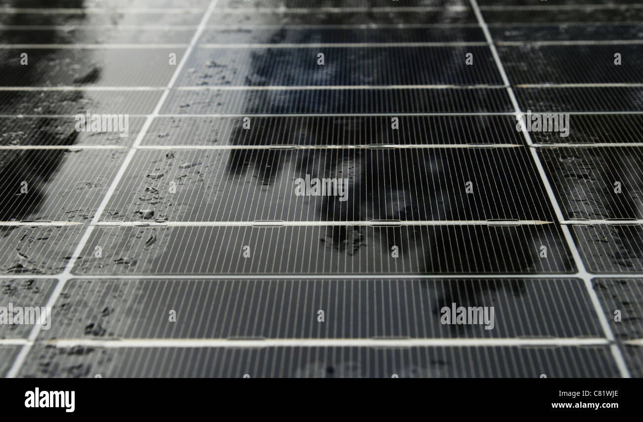 wet solar panel on a rainy cloudy day not generating much electricity Stock Photo
