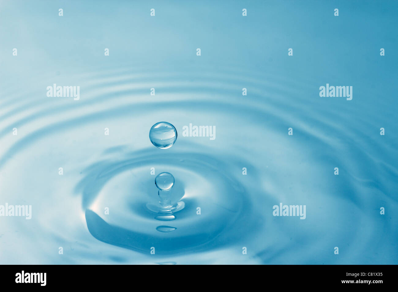 A drop of water splashes Stock Photo - Alamy