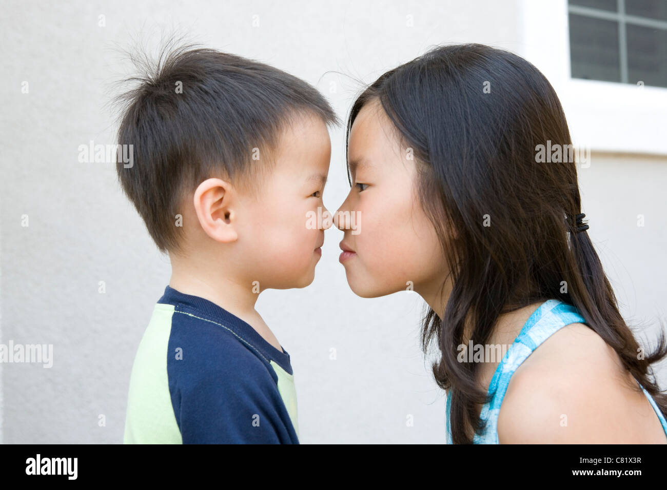 Chinese Brother And Sister Staring At One Another Stock Photo Alamy
