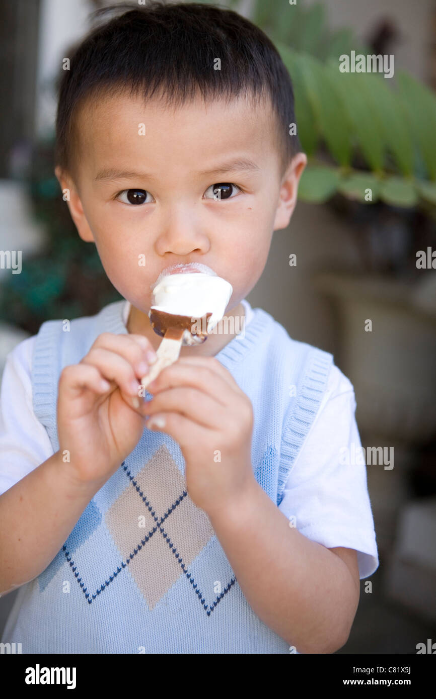 Chinese boy eating ice cream Stock Photo Alamy