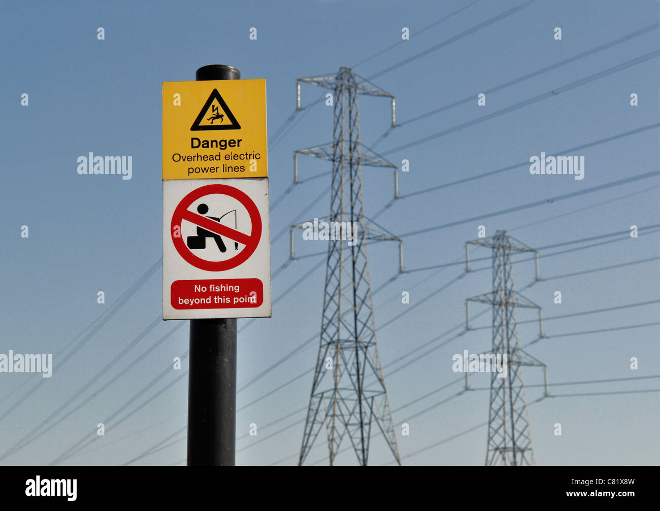 https://c8.alamy.com/comp/C81X8W/danger-no-fishing-overhead-electric-power-lines-sign-in-front-of-pylons-C81X8W.jpg