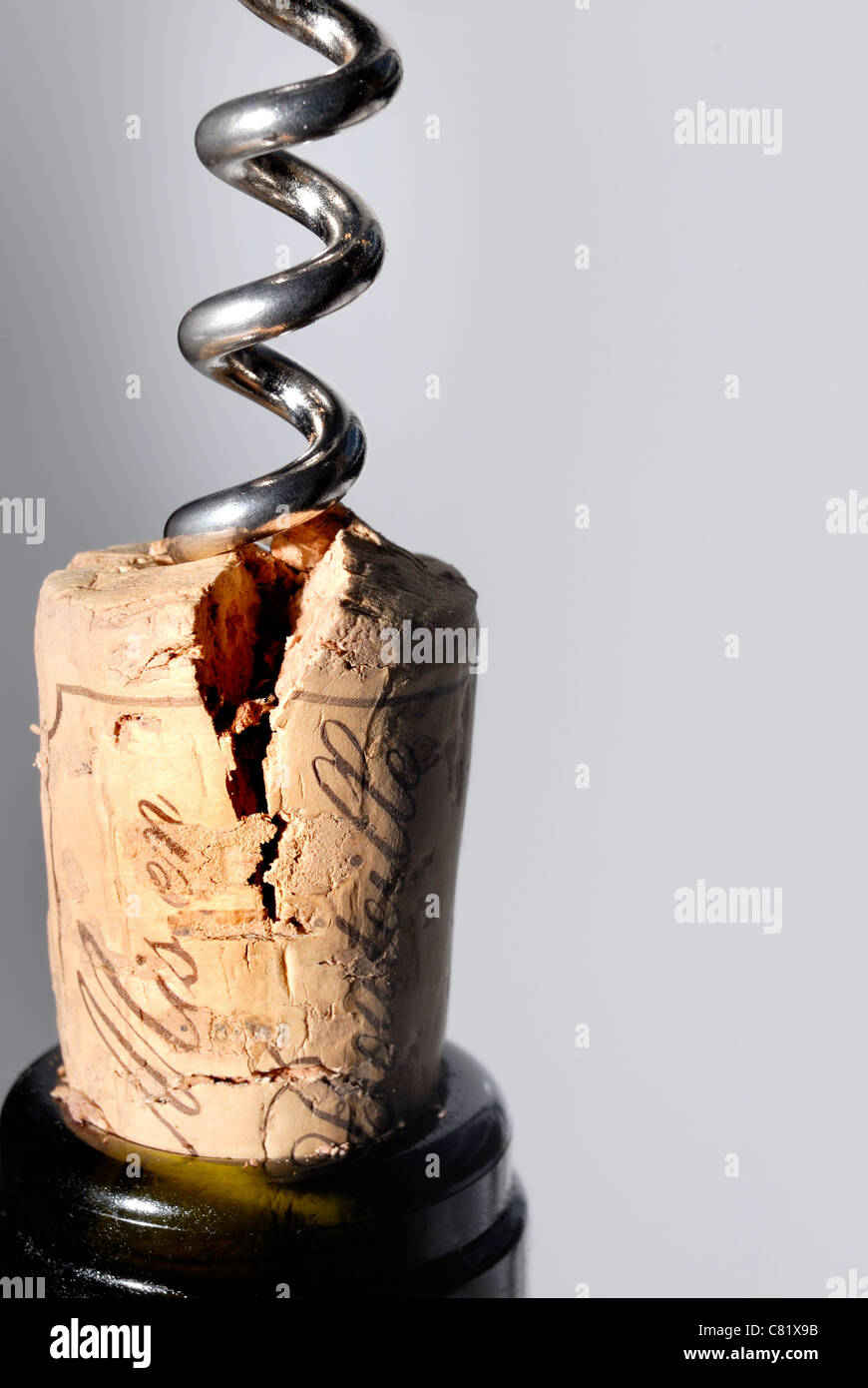Corkscrew pulling split cork from bottle Stock Photo Alamy