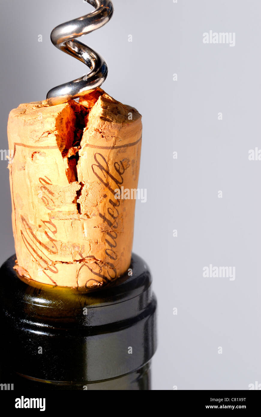 Corkscrew pulling split cork from hires stock photography and images