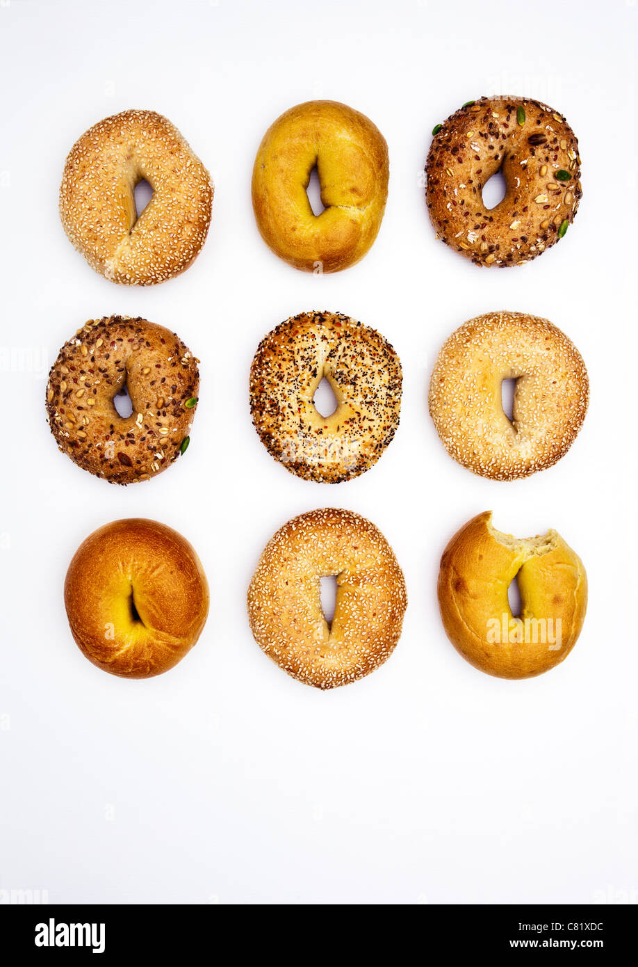 Various bagels, one with bite missing Stock Photo