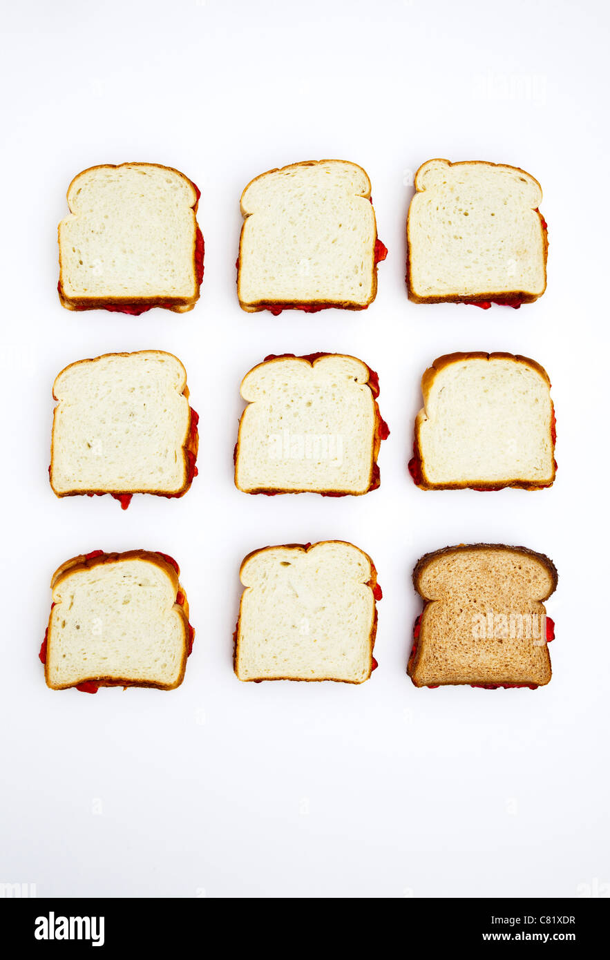 Peanut butter and jelly sandwiches, one on whole wheat bread Stock