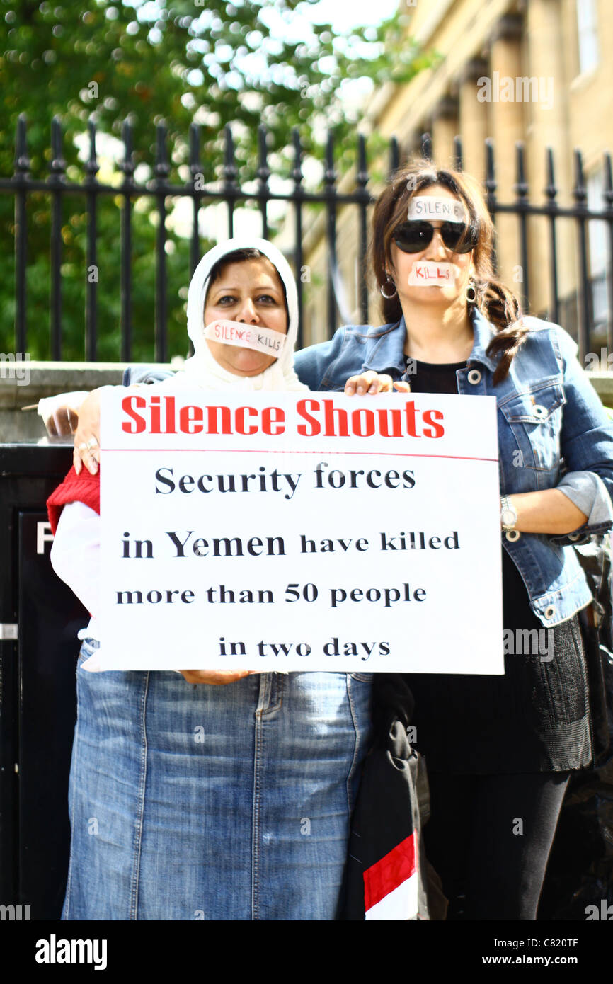 Two women taking part in a silent protest opposite Downing Street to highlight the political situation in Yemen. Stock Photo